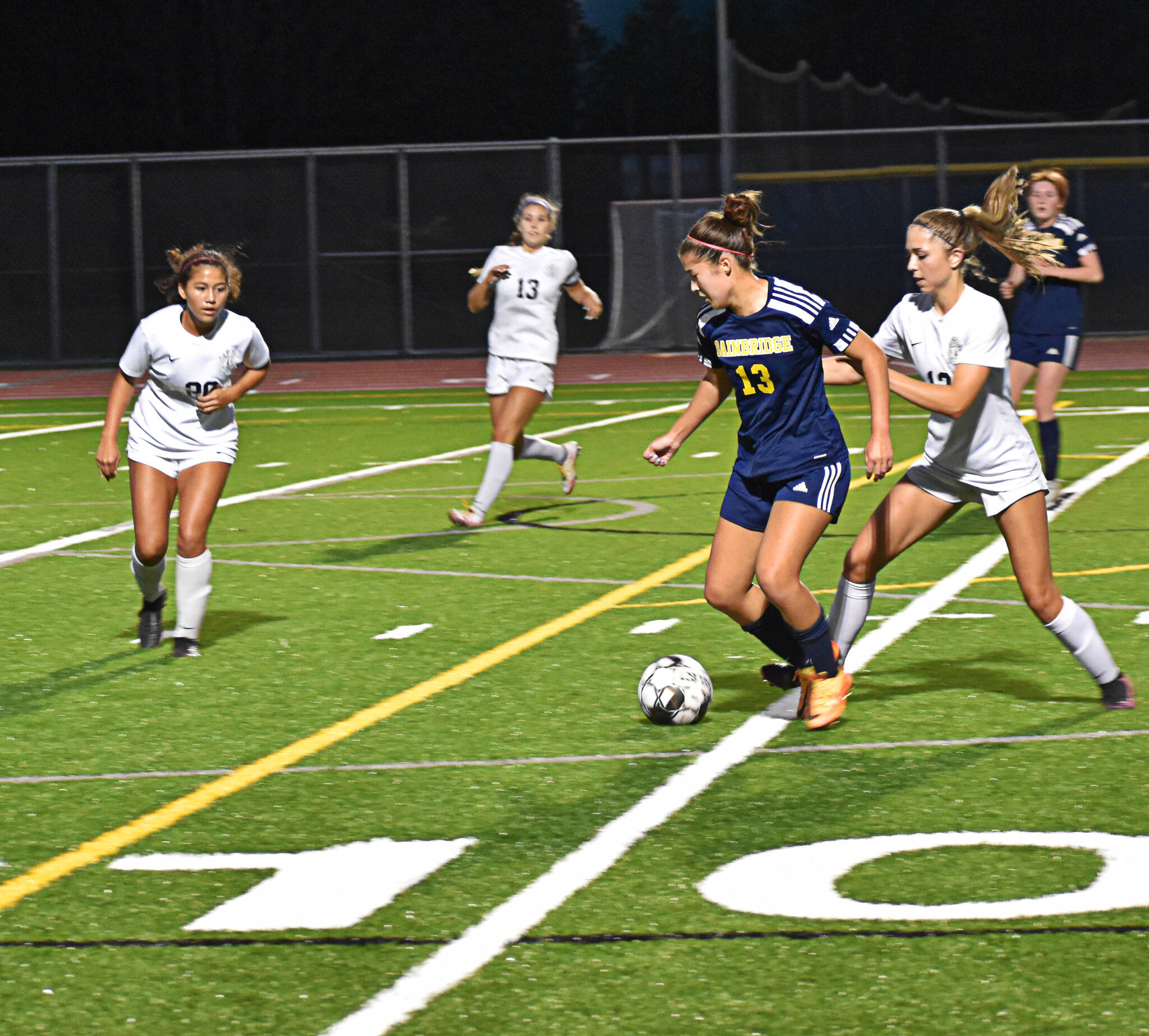 Bainbridge’s Hailey Fink pushes the ball to the attacking zone.