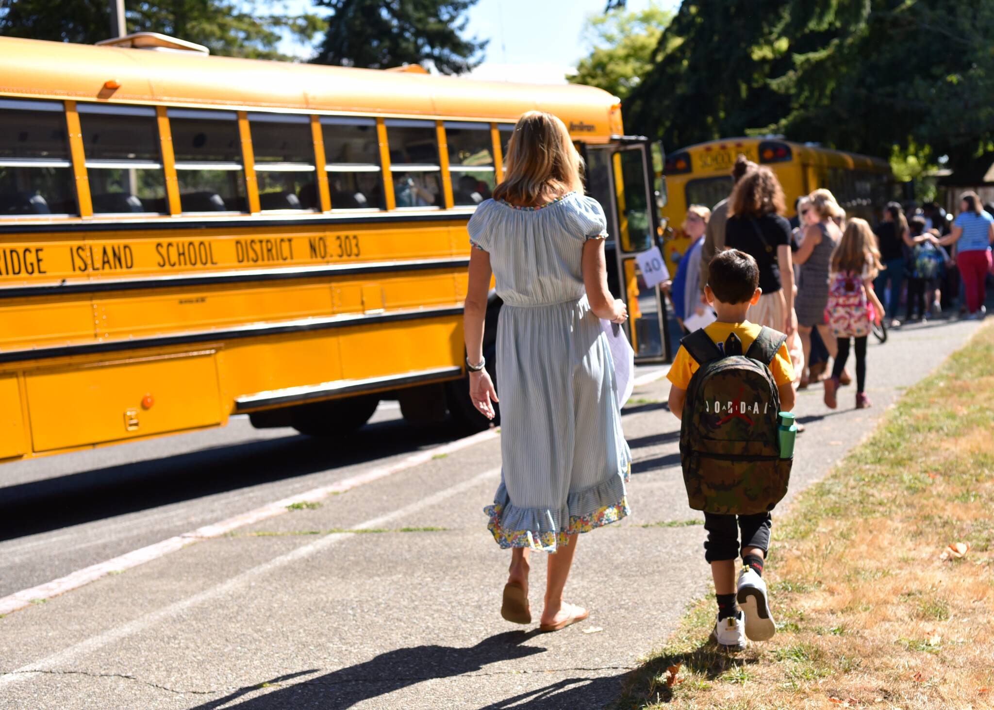 Ordway Elementary School second-grade teacher Vanessa Johnson escorts a student to the bus.