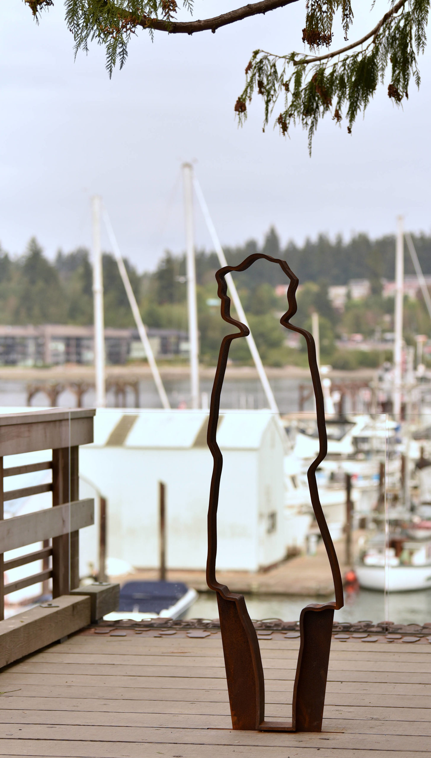 A ghost silhouette looks out at the harbor near the end of the Departure Deck.