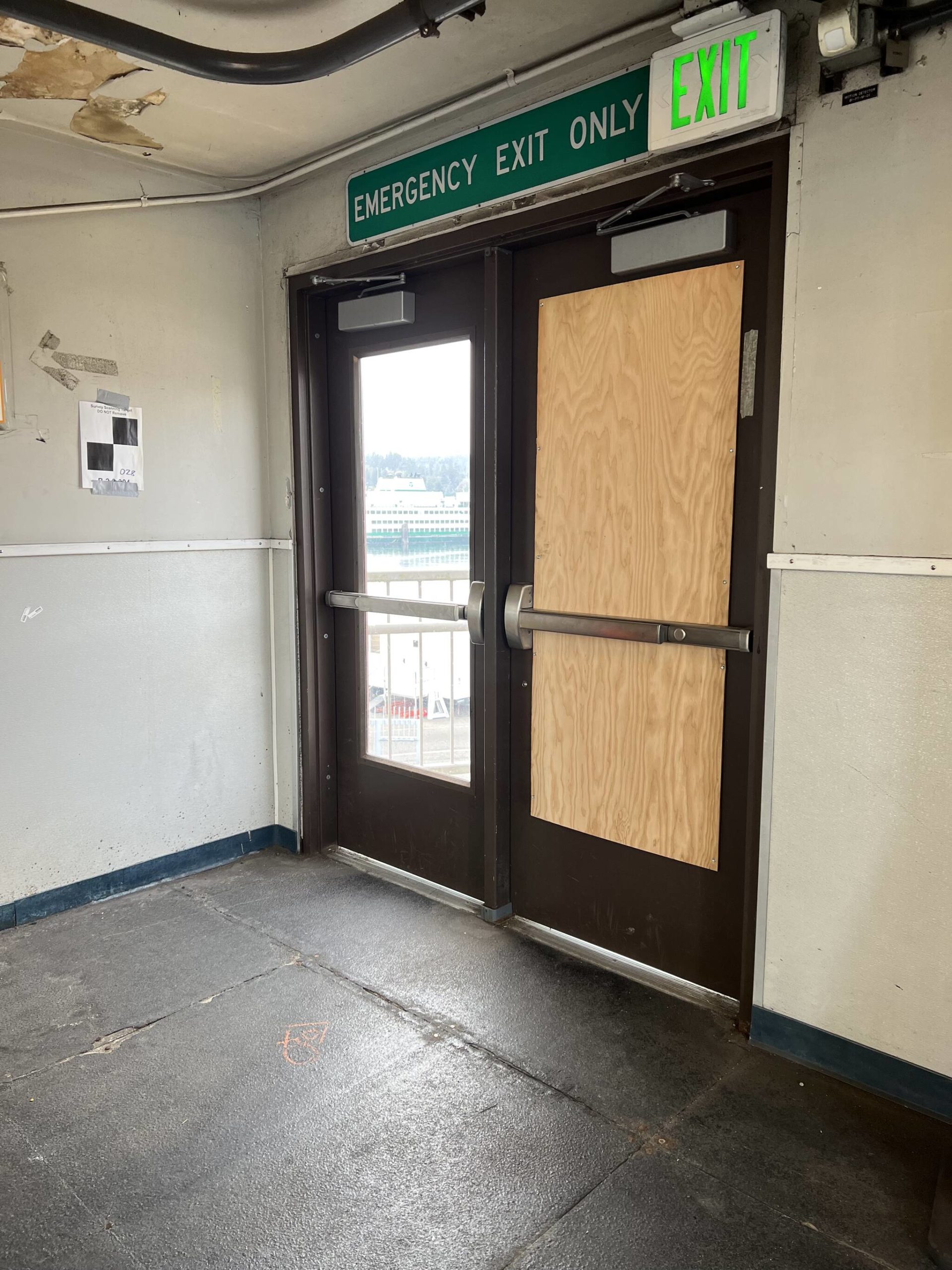 An exit door is repaired after a passenger broke it with a backpack while refusing to leave the terminal area Sept. 5.