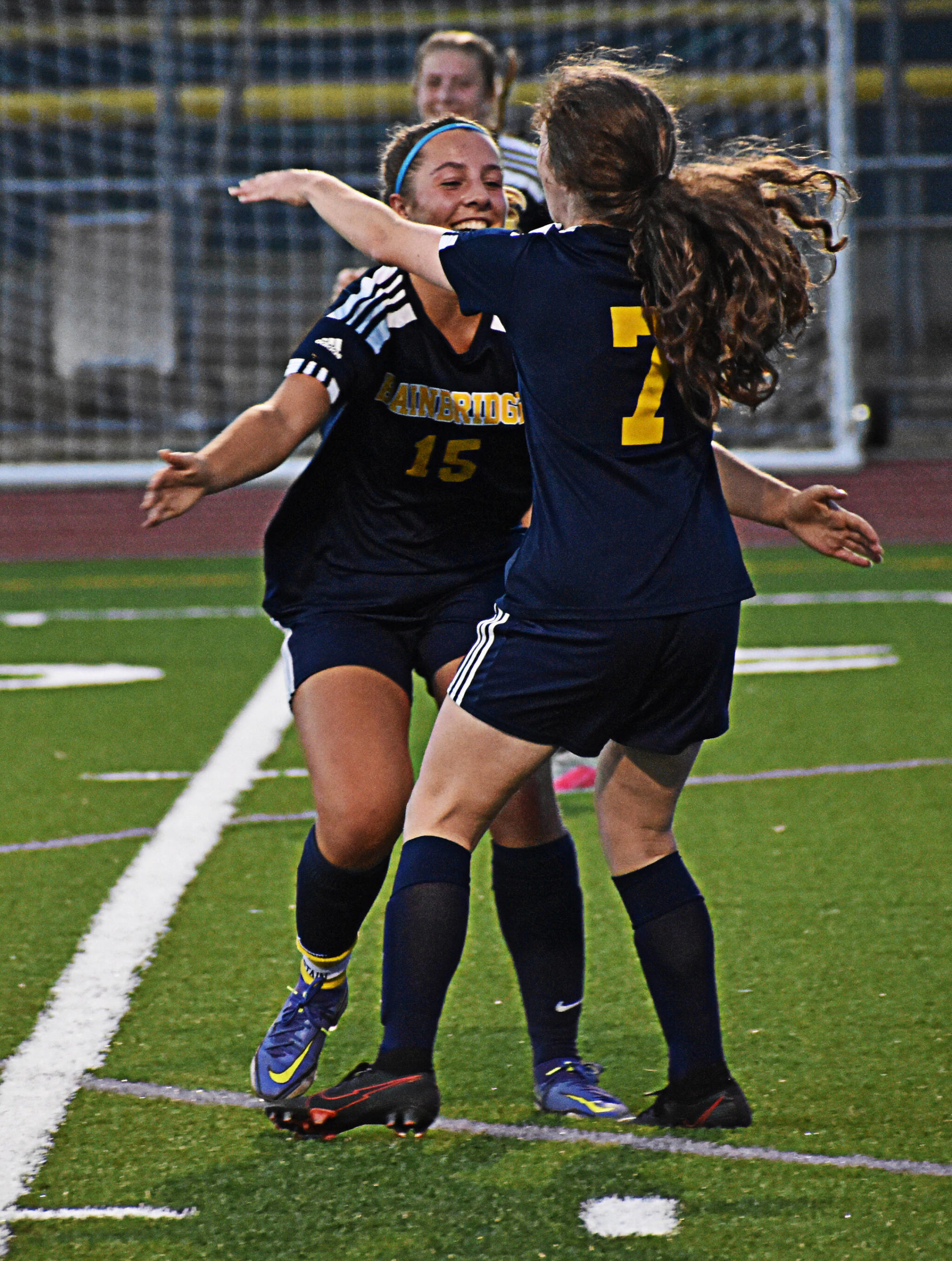 Gabby Weis celebrates with Savannah Mabee after scoring the first of four goals in the game. Nicholas Zeller-Singh/Bainbridge Island Review Photos