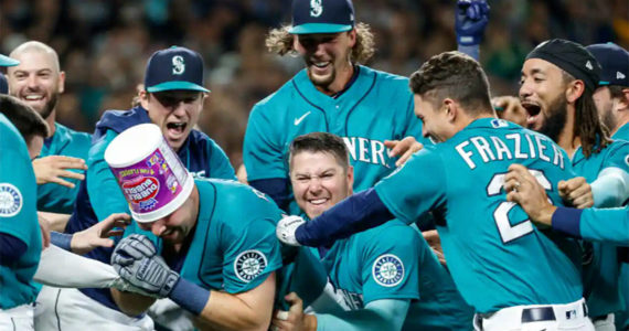 Cal Raleigh celebrates with his teammates after hitting a walk-off home run to send the Mariners to the postseason for the first time in 21 years. Getty Images Courtesy Photo