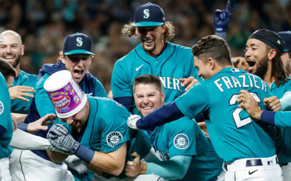 Cal Raleigh celebrates with his teammates after hitting a walk-off home run to send the Mariners to the postseason for the first time in 21 years. Getty Images Courtesy Photo