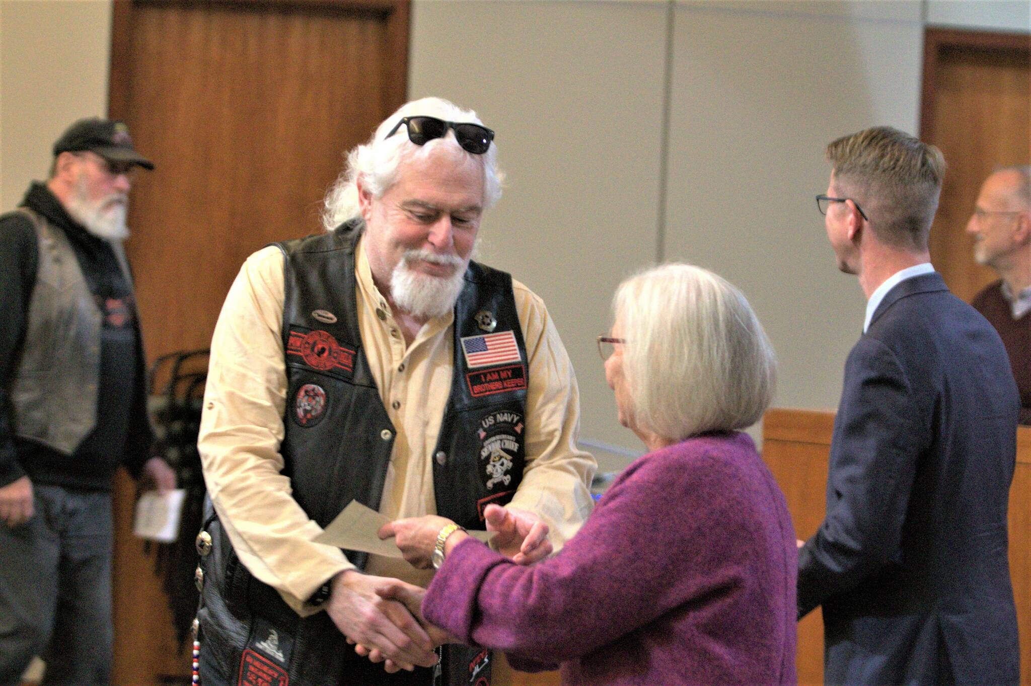 A veteran receives a congressional declaration with the pin.