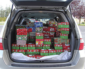 A trunk full of shoeboxes packed with small gifts at a drop-off site. Courtesy Photo