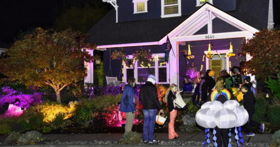 Kids line up for treats at a home in the popular North Town Woods neighborhood. Nancy Treder/Kitsap News Group Photos