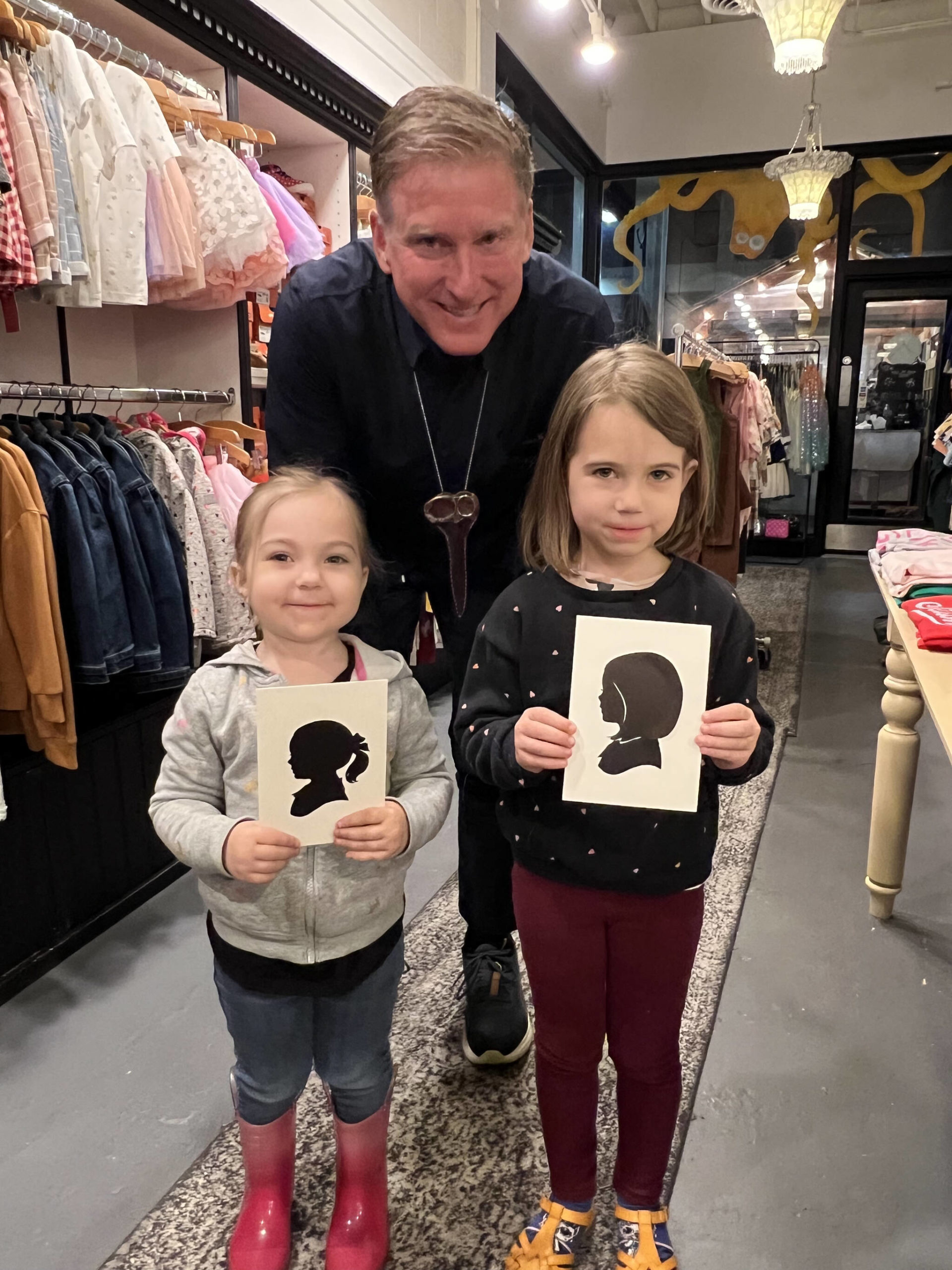 Kimberly and Scarlett Wisner pose with their paper silhouettes with artist Karl Johnson Nov. 9 in Winslow.
