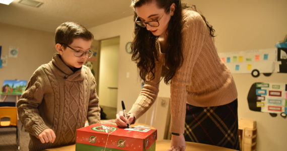 Sam and Adriana Garrard prepare a shoebox for shipping. Nancy Treder/Kitsap News Group Photos