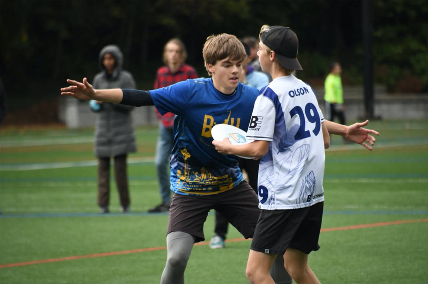 Calder Lange plays tight defense against an Eastside Prep thrower in the Washington State high school Ultimate tournament.