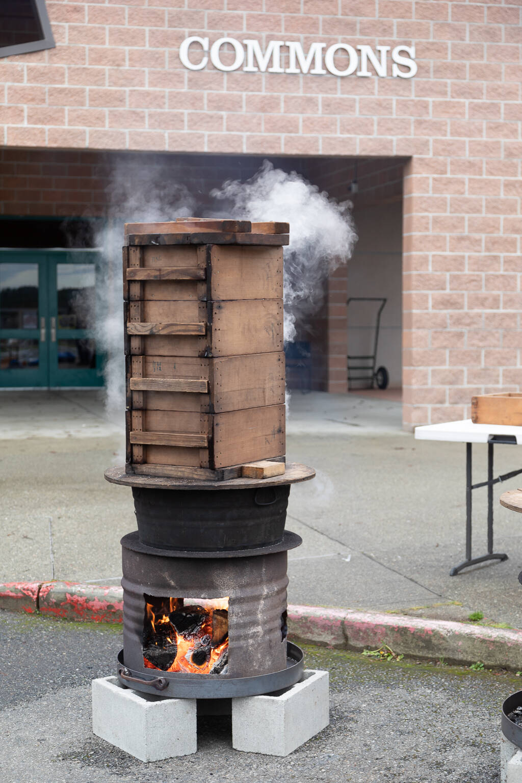 Sweet rice is steamed in wooden boxes over an open fire as it has been done for nearly a thousand years.