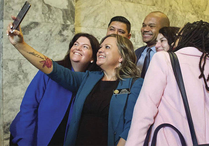 State Rep. Tarra Simmons, D-Bremerton, snaps a selfie with friends and associates on the opening day of the state Legislature Jan. 9. Renee Diaz/Courtesy Photo