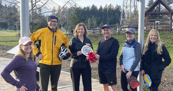 Anniken Krutnes, center, the first woman named Norway’s Ambassador to the United States, receives a replica of the first Pickleball paddle from Sean Megy, director of the Bainbridge Island Founders’ Tournament, Sunday on Bainbridge Island, the birthplace of the sport. Left to right are: Erin Prince, superintendent of Central Kitsap Schools; Gov. Jay Inslee; Krutnes; Megy; Lise Kristiansen, Norwegian Honorary Consul for Alaska; and Jacqueline Miller, Belgian Honorary Consul for Washington. The dignitaries were on BI for the announcement of the 2023 tournament to be held Aug. 9-13 at Battle Point Park. Tom Kelly Courtesy Photo