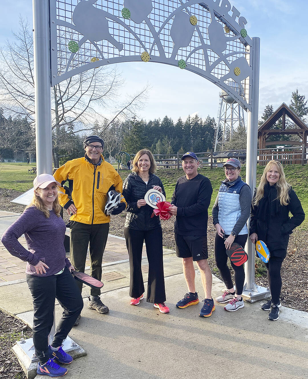 Anniken Krutnes, center, the first woman named Norway’s Ambassador to the United States, receives a replica of the first Pickleball paddle from Sean Megy, director of the Bainbridge Island Founders’ Tournament, Sunday on Bainbridge Island, the birthplace of the sport. Left to right are: Erin Prince, superintendent of Central Kitsap Schools; Gov. Jay Inslee; Krutnes; Megy; Lise Kristiansen, Norwegian Honorary Consul for Alaska; and Jacqueline Miller, Belgian Honorary Consul for Washington. The dignitaries were on BI for the announcement of the 2023 tournament to be held Aug. 9-13 at Battle Point Park. Tom Kelly Courtesy Photo