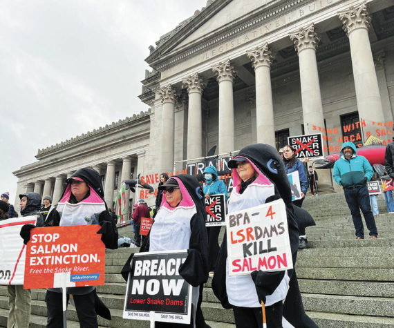 <p>Members of the Washington Youth Ocean and River Conservation Alliance and the Earth Ministry/Washington Interfaith Power & Light march from the Olympia Ballroom to the steps of the Capitol Jan. 13. Renee Diaz Courtesy Photo</p>