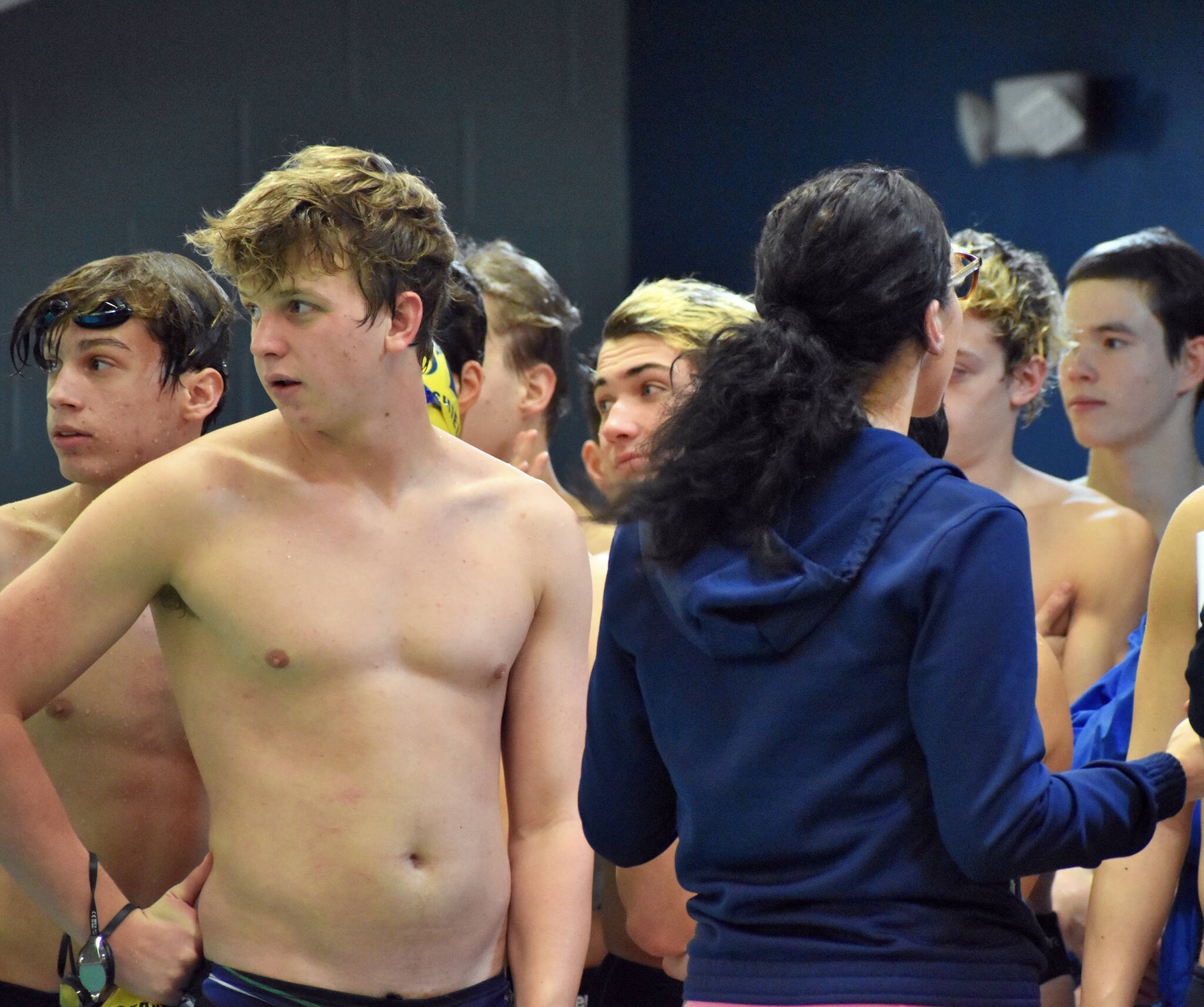 The Bainbridge Spartans look across the pool to scout their rivals before the swim meet begins.