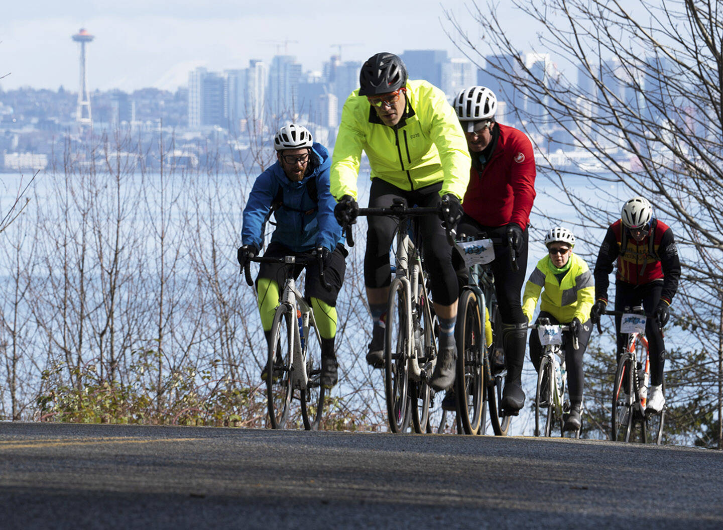 Bicyclists climb another Bainbridge Island hill with the Seattle Center and skyline in the background.
Bicyclists climb another Bainbridge Island hill with the Seattle Center and skyline in the background. Simon Hoke Courtesy Photo