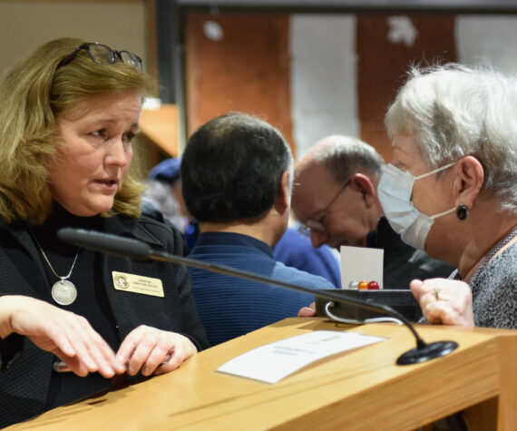 State Sen. Christine Rolfes speaks with a constituent after the Town Hall meeting. Nancy Treder/Kitsap News Group photos