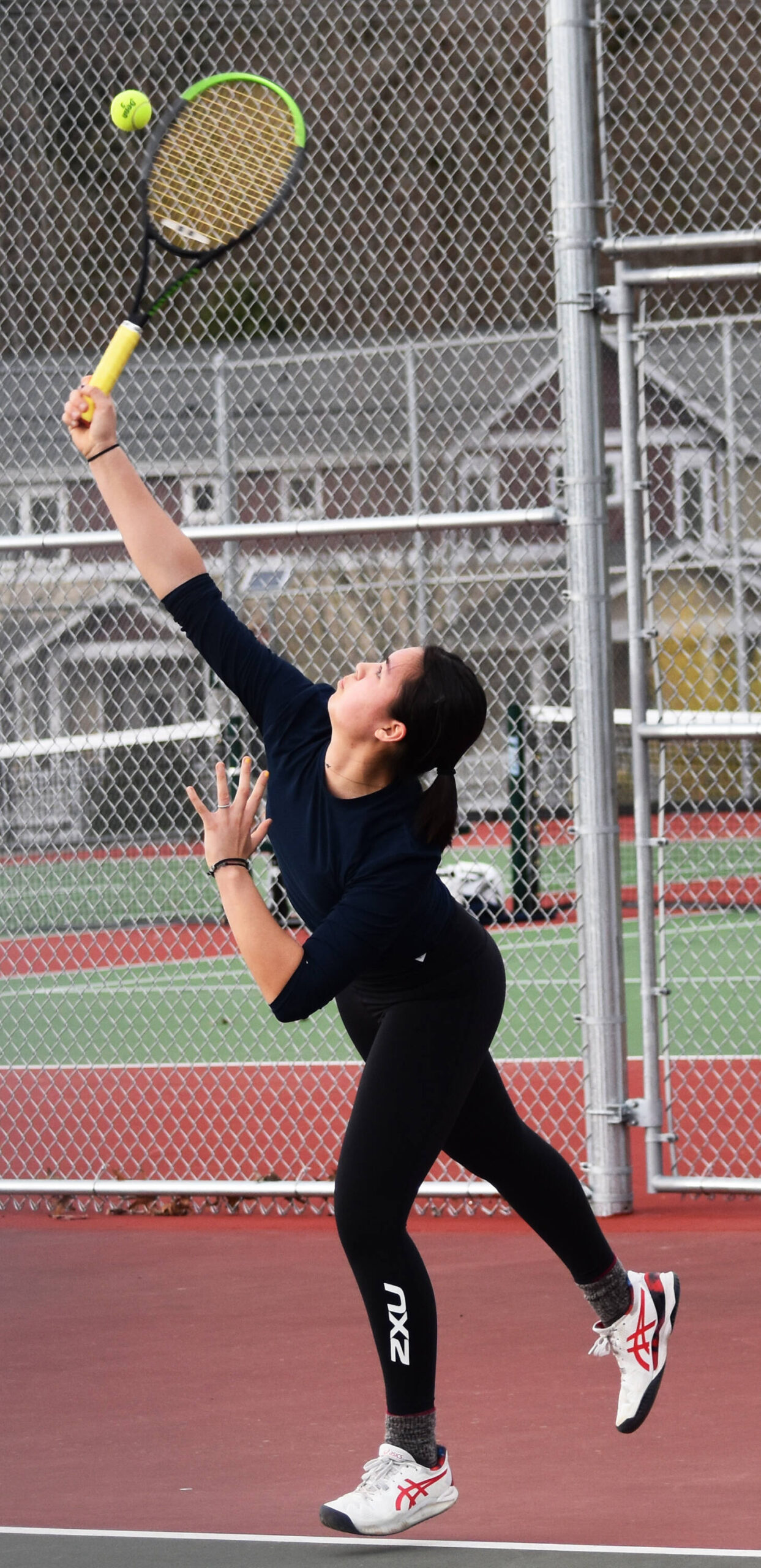 Bainbridge’s Izzy Wallin serves the ball to her opponent.