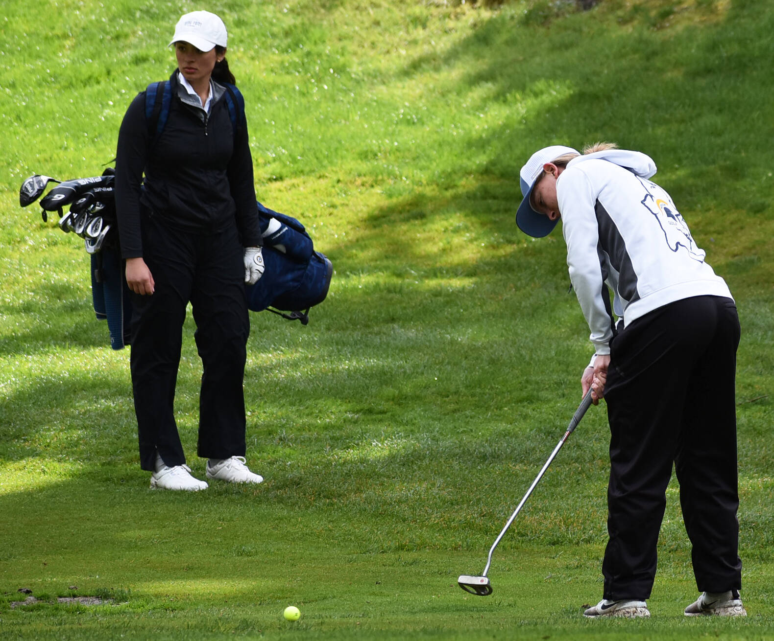 Bainbridge’s Elise Walters puts some power on her putt to make sure it can get through the wet green.
