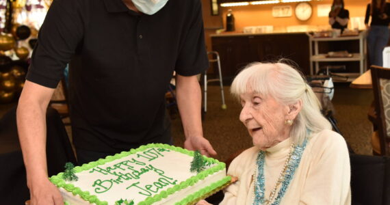 Jean Wohlsen receives a cake on her 107th birthday, April 17, at her residence in the Madison House in Bainbridge Island. Nancy Treder/Kitsap News Group Photos