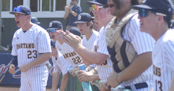 Spartans cheer after Duncan Bos hits a triple. Steve Powell/Kitsap News Group