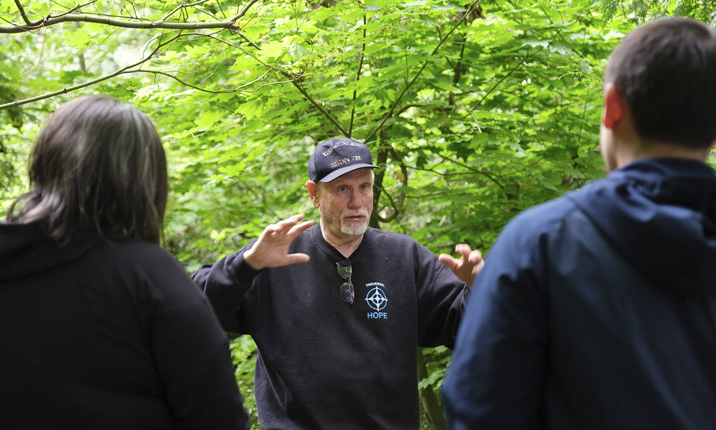 Al Phillips talks to visitors on a recent tour of his property, called Dolphin Place Open Space.