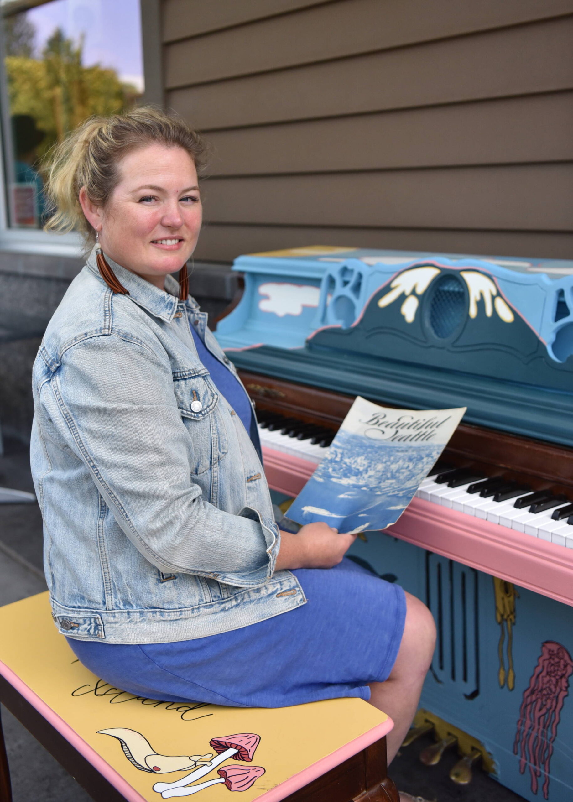 Stina Tillotson sits at the piano she donated for the public piano project. Nancy Treder/Kitsap News Group Photos