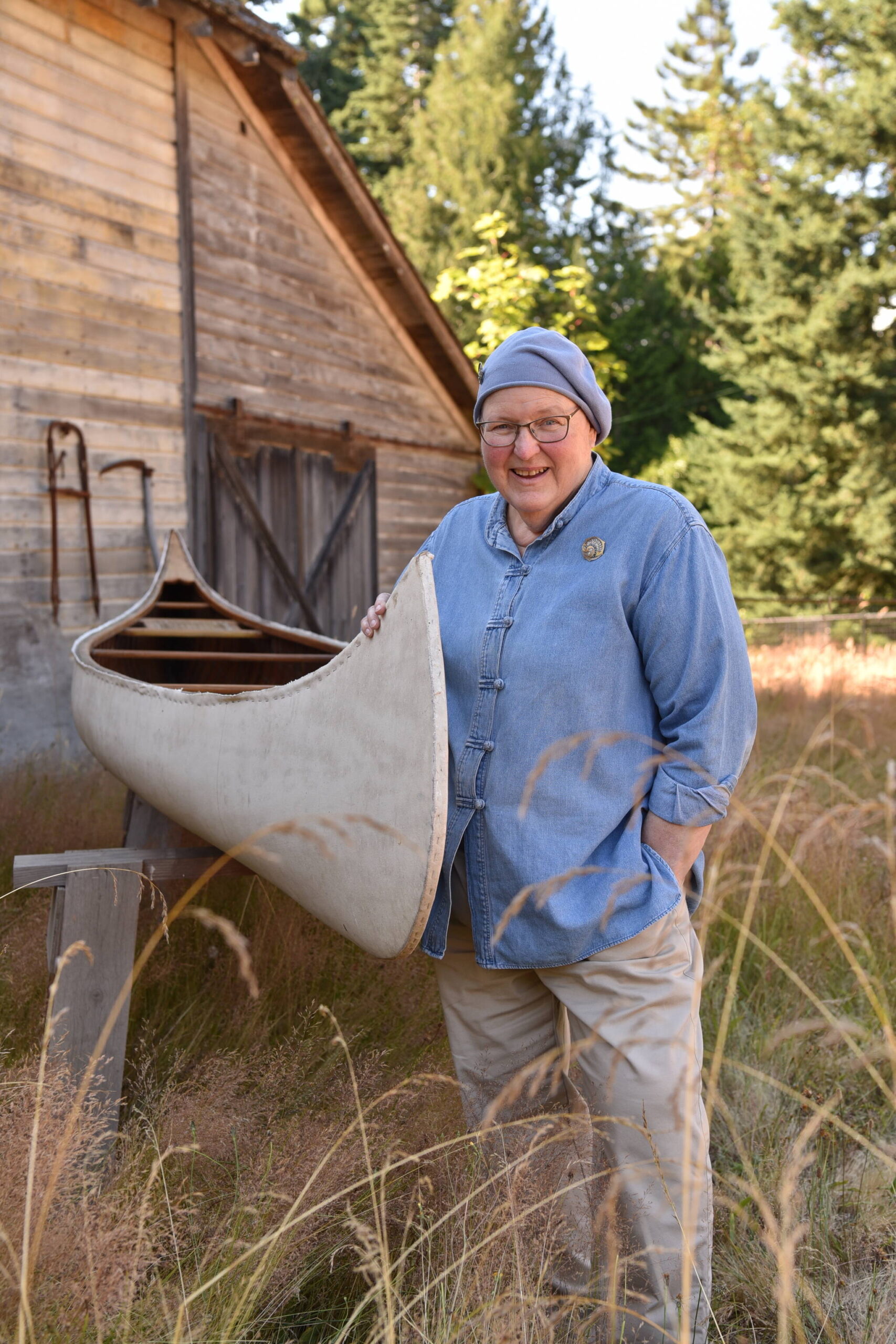 Susan Goodwin poses with a 100-year-old canoe she purchased from the Vick family 40 years ago.