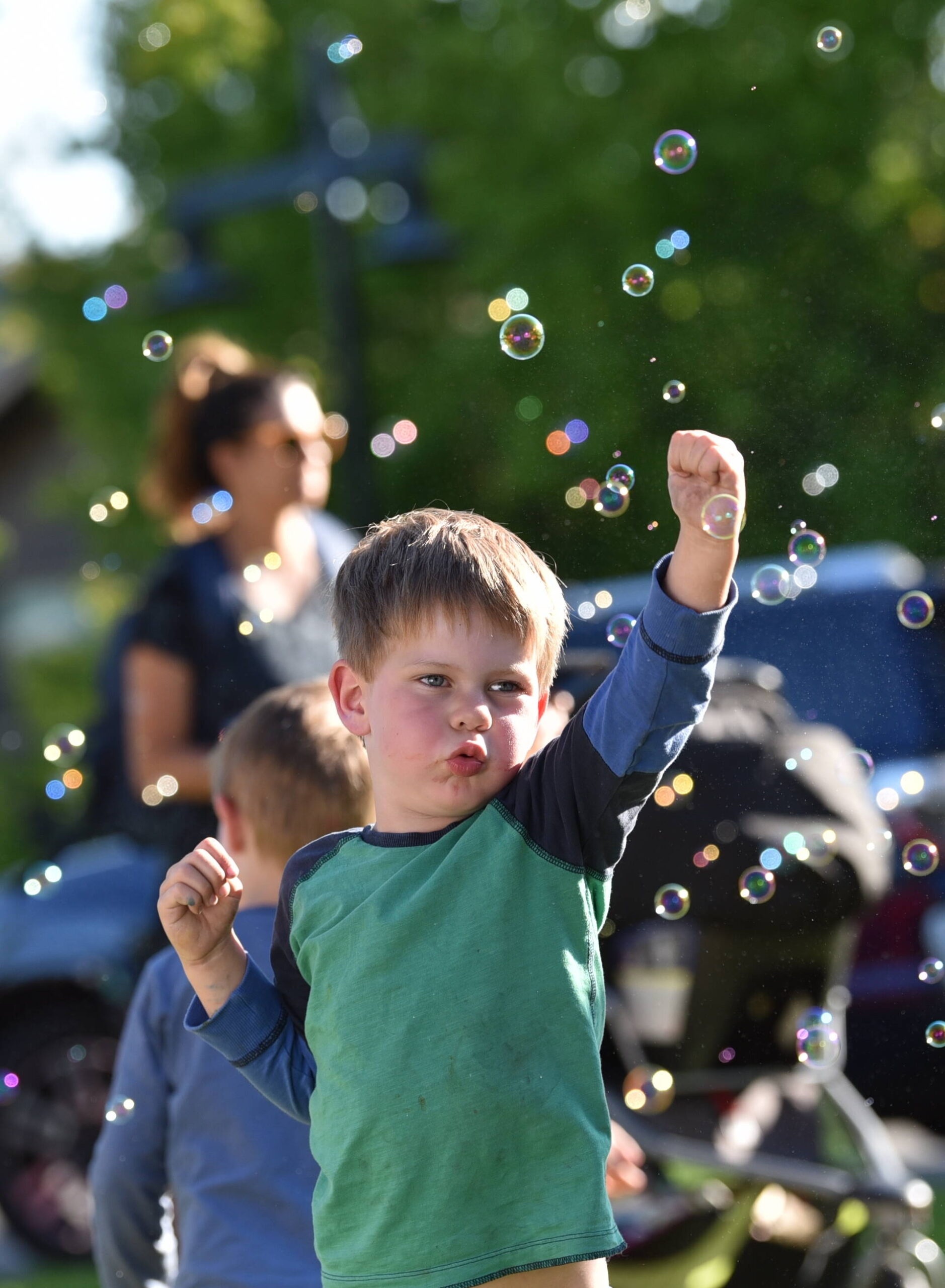 Henry Allison, 4, enjoys punching bubbles at the KiDiMu activity area during the National Night Out community event held at Town Center Aug. 1.