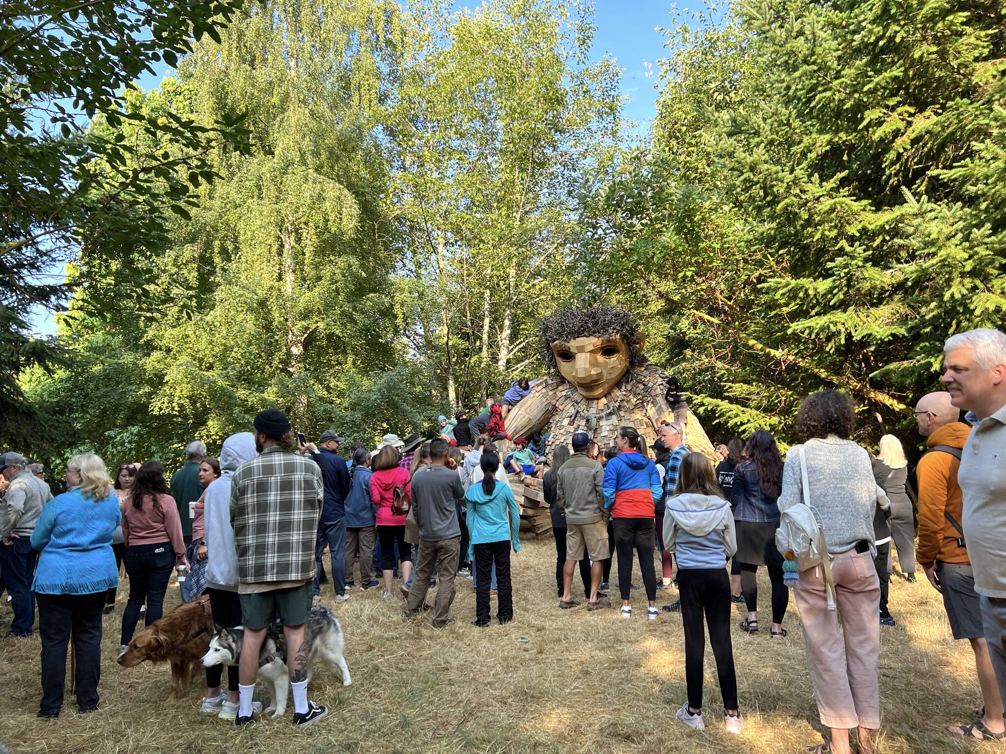 People gather at Sakai Park at 8:19 a.m. to wake up Pia the Peaceful troll Aug. 19.