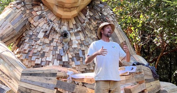 Nancy Treder/Kitsap News Group 
Recycle artist Thomas Dambo speaks about Pia the Peacekeeper troll that was made from recycled materials and completed by his team and community volunteers Aug. 18 at Sakai Park.