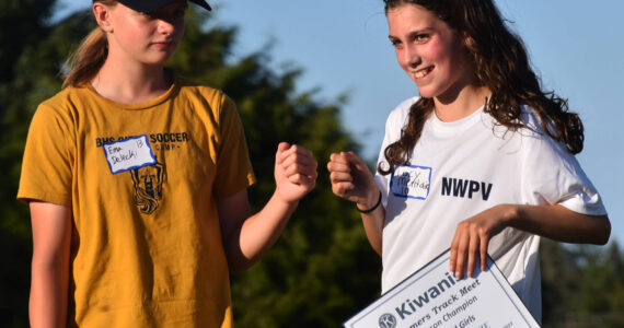 Nicholas Zeller-Singh/Kitsap News Group Photos
Ema Delecki and Lucy McRitchie fist bump after having two of the three highest combined points in all five recorded meets.