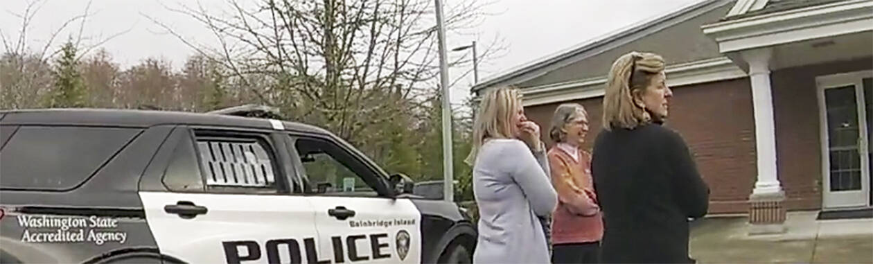 BI police courtesy photo
Adults try to get the boy to calm down in a Bainbridge Island police car in a church parking lot.