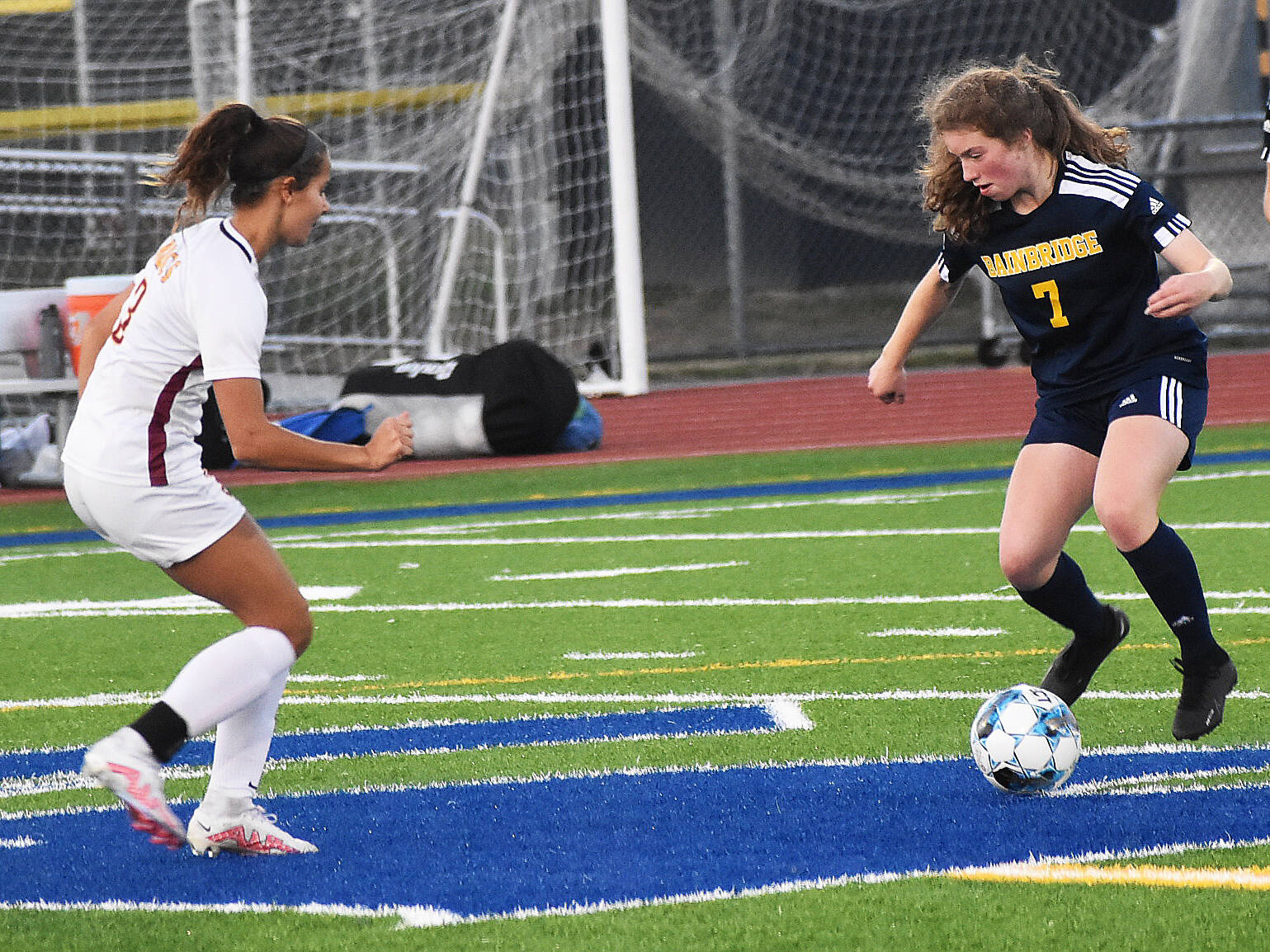 Spartan Gabby Weis challenges Buc Kate Collins for the ball.