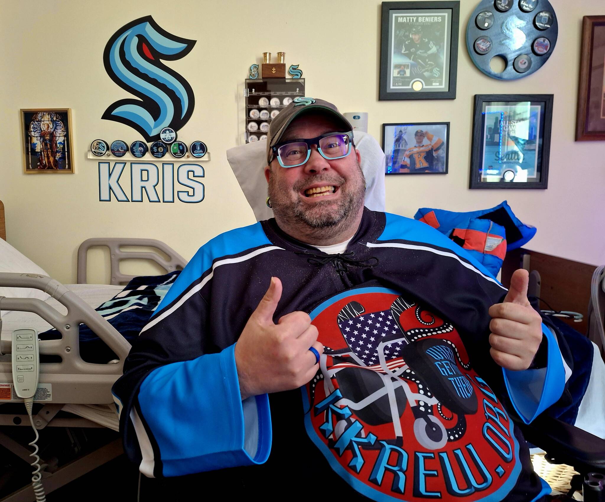 Elisha Meyer/Kitsap News Group
Kris Boudreau shows off his sports memorabilia collection, as well as his signature greeting.