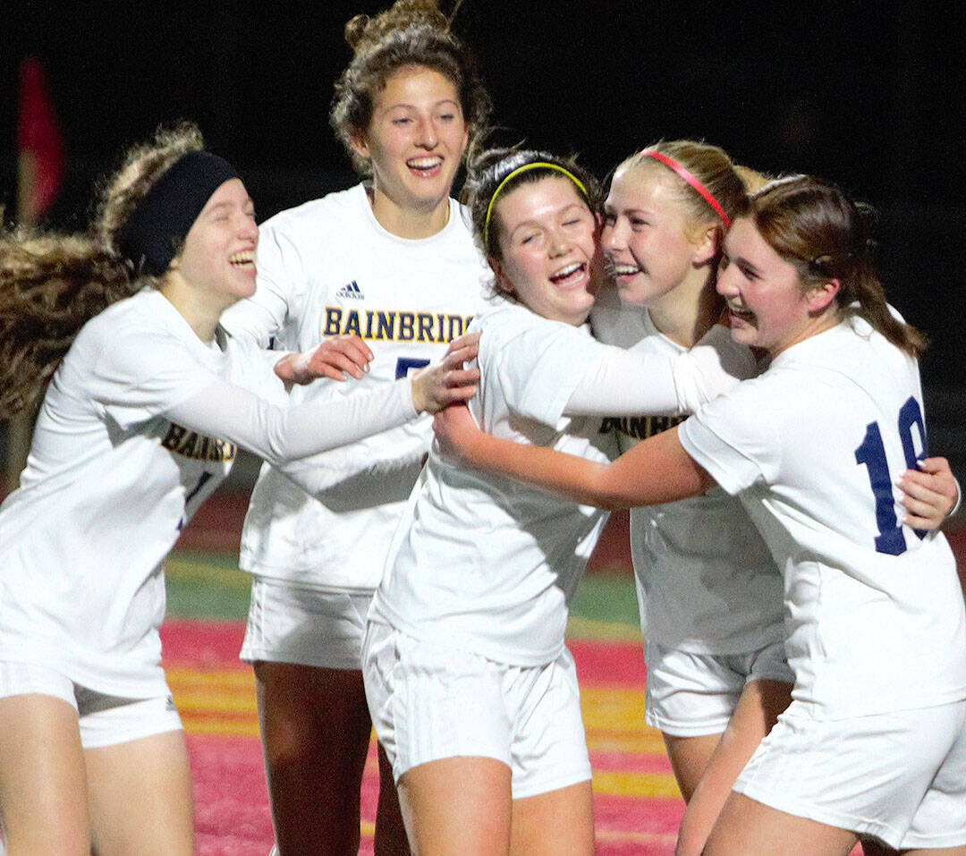 Elisha Meyer/Kitsap News Group
Junior Arden De Lanoy (second from right) is mobbed by teammates after scoring the go-ahead goal in regulation against Lakes.