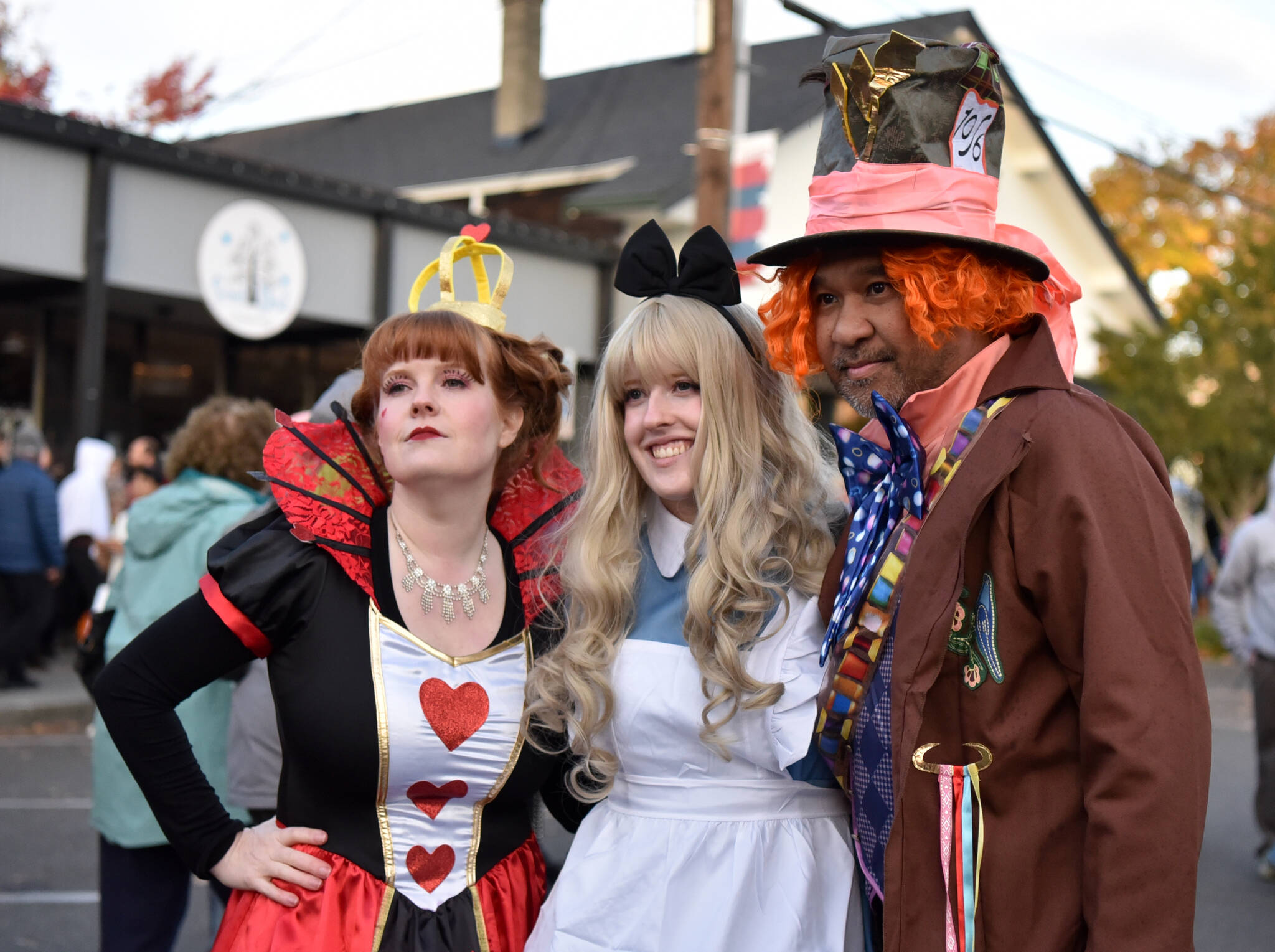 Alice in Wonderland, the Queen of Hearts and the Mad Hatter pose for a photo at the event.