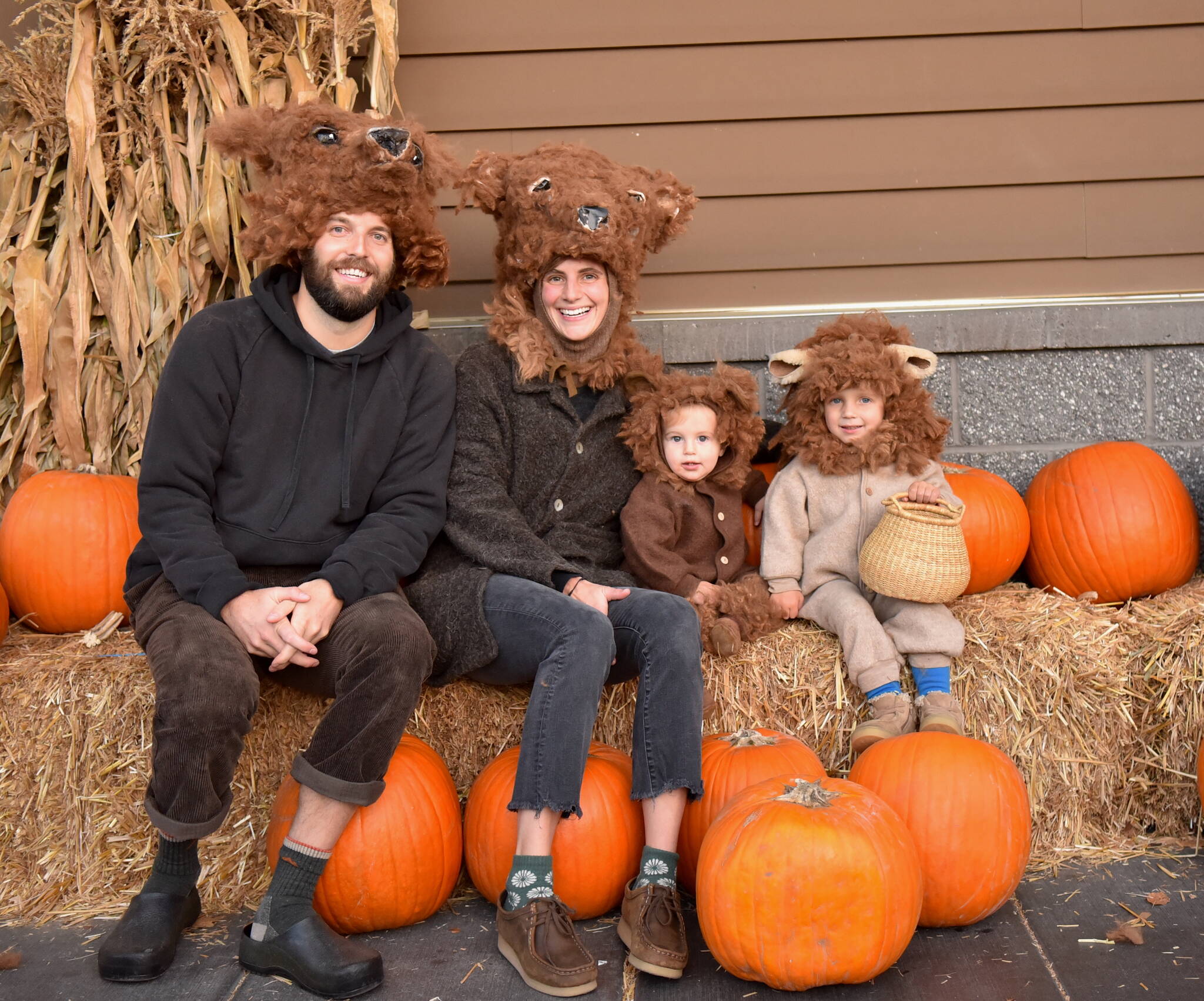 A bear family poses for photos in the pumpkin patch at Town & Country market.