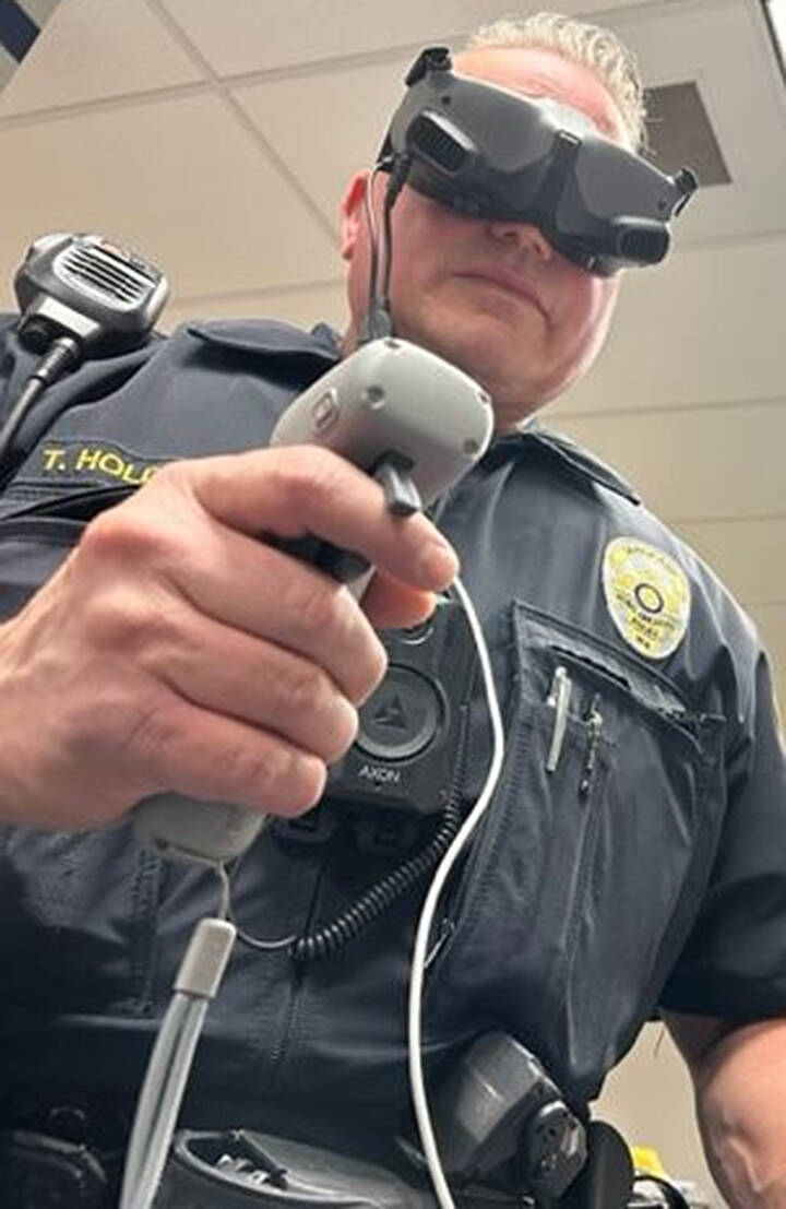 Sgt. Trey Holden wears a headset so he can see where to guide the drone.
