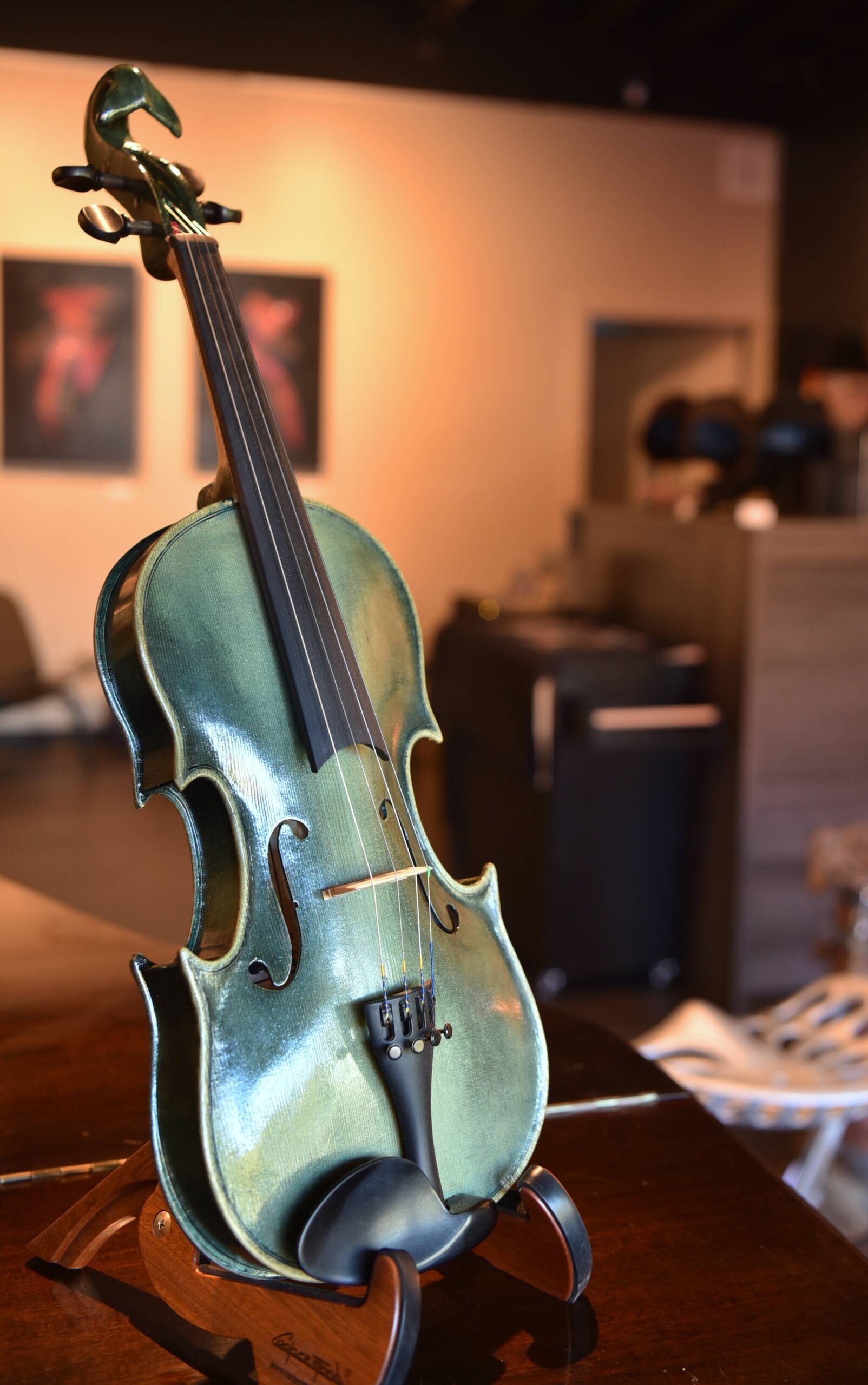 A green violin with Orca features on display in the studio is one of several items made by local artists.