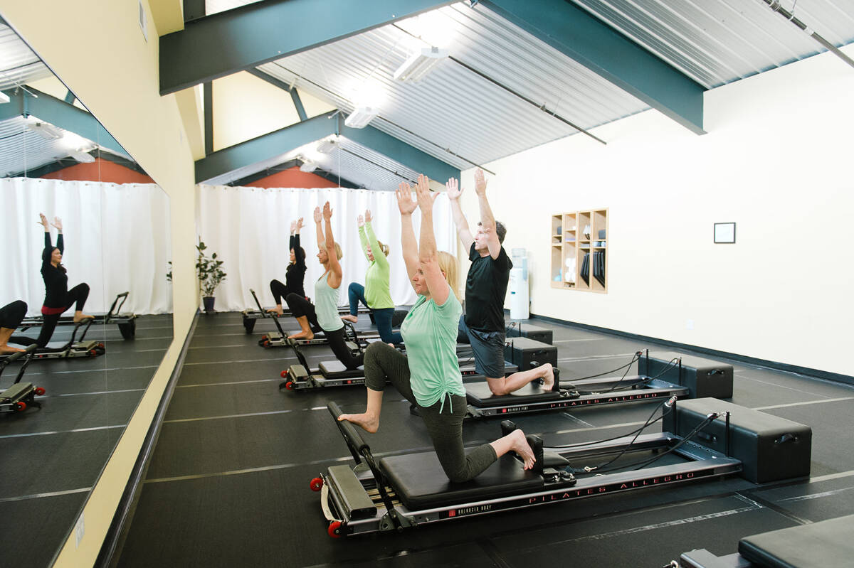 Arlene Harris leads a session at The Pilates Studio at New Motion on a device known as the Reformer.