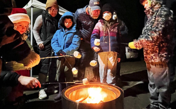 Nancy Treder/Kitsap News Group Photos
Roasting marshmallows was just one of many activities going on Nov. 25 in Winslow to celebrate the holiday season. The annual tree-lighting event included performances by local bands and choirs.