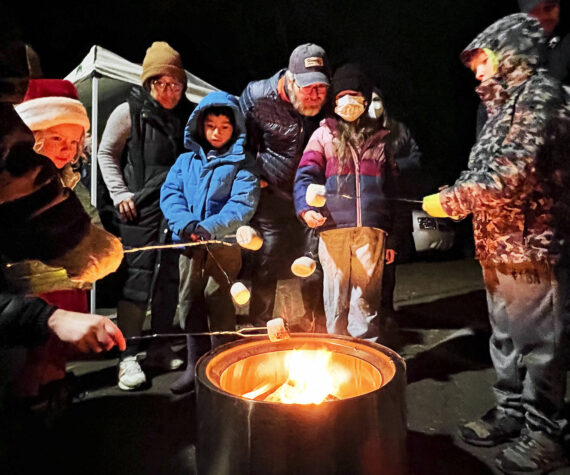 Nancy Treder/Kitsap News Group Photos
Roasting marshmallows was just one of many activities going on Nov. 25 in Winslow to celebrate the holiday season. The annual tree-lighting event included performances by local bands and choirs.