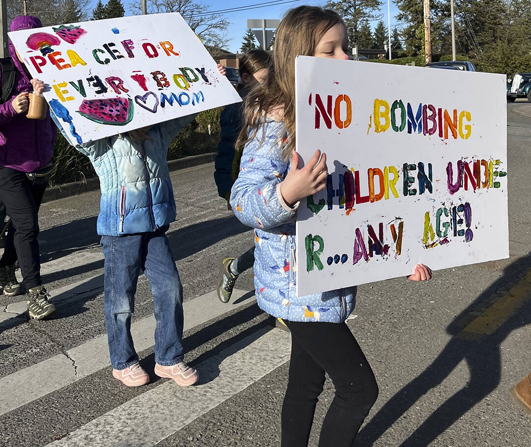 Students carry signs during the march for peace Jan. 15.