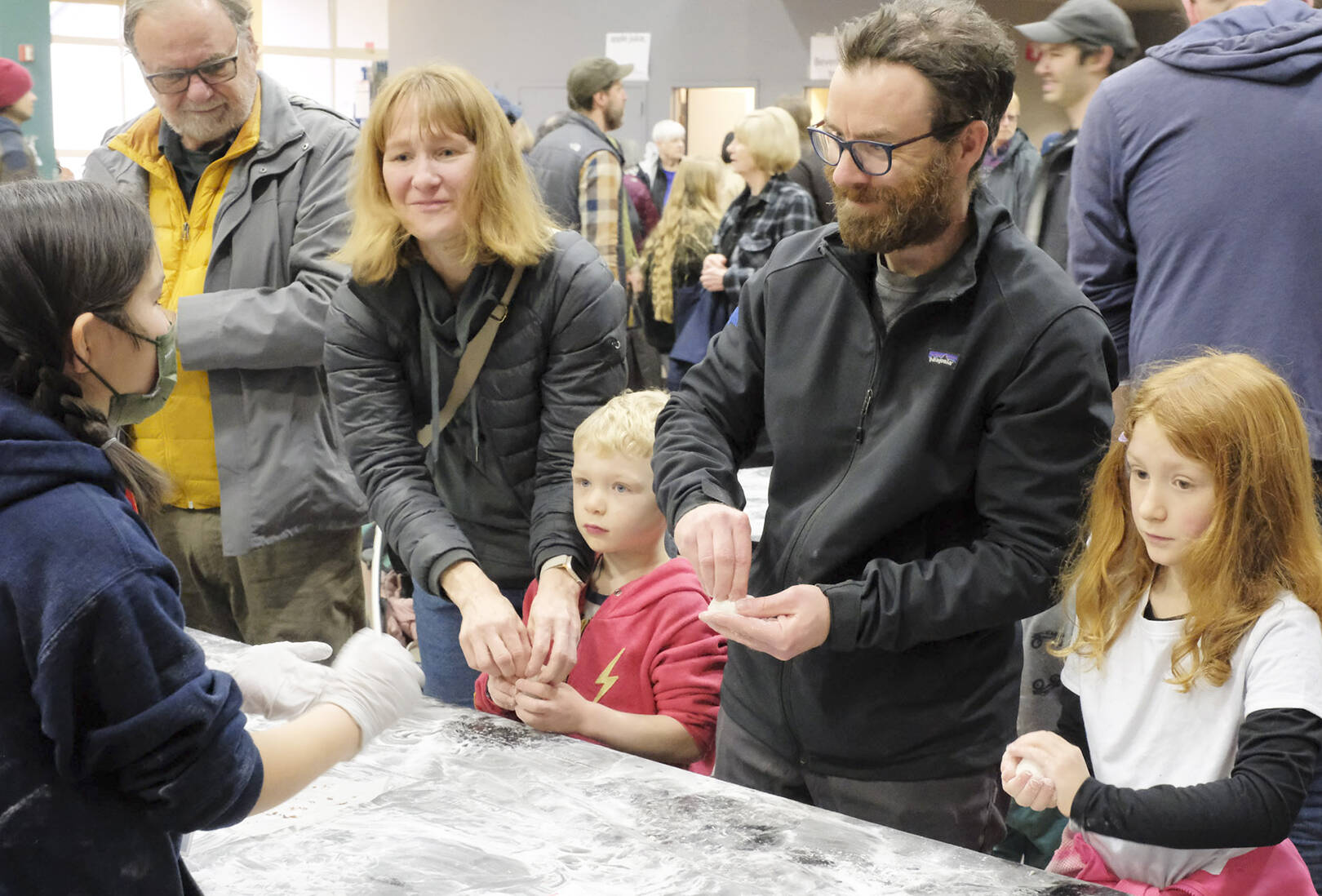People of all ages enjoy the event through hands-on activities like molding the mochi dough.
