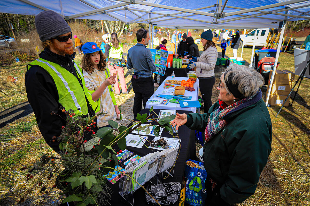 Jeannette Franks, right, instructs a volunteer Weed Warrior on the dangers of invasive plants.