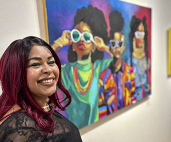 <p>BIMA courtesy photos</p>
                                <p>Fancy Vargas next to some of the art at the display.</p>