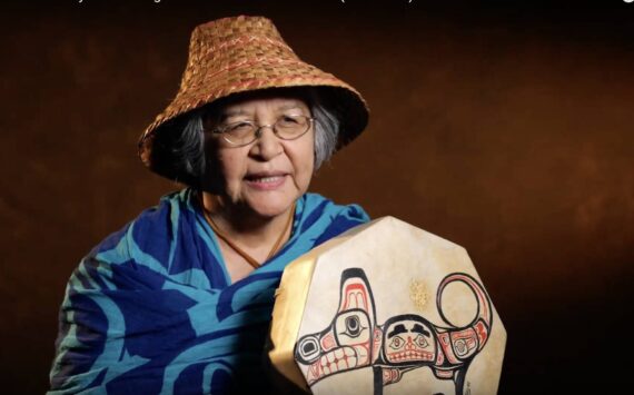 Molly Hetherwick/Kitsap News Group
Indipino elder Bethany Mapanao displays the drum her brother painted for her with an image of her animal, a wolf. She is also wearing a woven cedar hat from the Lummi tribe, which she “wears with pride.”