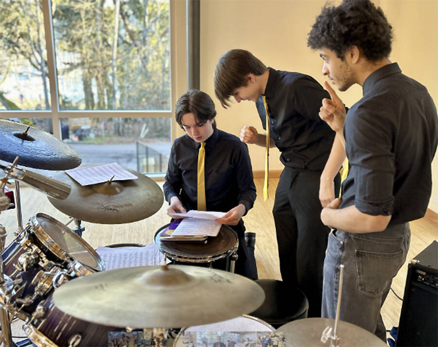 Musicians look over their setlist.