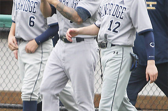 File photos
Geoff Brown celebrates with his team after a playoff victory in Everett.